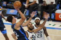 Oklahoma City Thunder center Isaiah Roby, left, shoots in front of Utah Jazz center Rudy Gobert, center, and forward Royce O'Neale (23) in the second half of an NBA basketball game Friday, May 14, 2021, in Oklahoma City. (AP Photo/Sue Ogrocki)