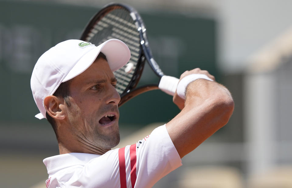 Serbia's Novak Djokovic plays a return to Italy's Lorenzo Musetti during their fourth round match on day 9, of the French Open tennis tournament at Roland Garros in Paris, France, Monday, June 7, 2021. (AP Photo/Michel Euler)