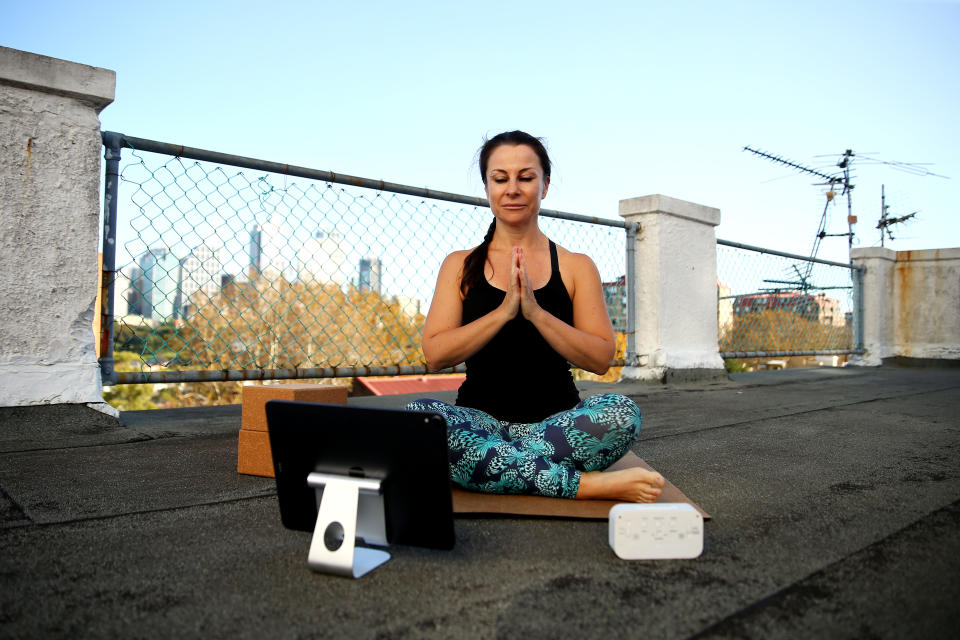 SYDNEY, AUSTRALIA - MAY 08: Rachel Falconer hosts an online yoga class from the rooftop of her Kings Cross apartment building on May 08, 2020 in Sydney, Australia. Rachel Jane Falconer, known as the playfulyogawarrior, is a Sydney based movement and meditation teacher who has developed an online program for people to help ease the physical and mental impact of working from home during the COVID-19 pandemic. (Photo by Don Arnold/Getty Images)