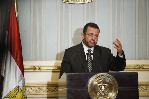 Egyptian Prime Minister Hisham Qandil gestures as he gives a press conference in Cairo