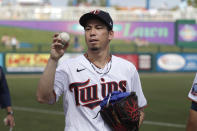 Minnesota Twins starting pitcher Kenta Maeda tosses a ball to a fan before pitching against the Boston Red Sox in a spring training baseball game Monday, Feb. 24, 2020, in Fort Myers, Fla. (AP Photo/John Bazemore)