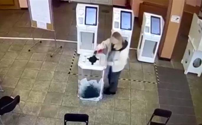 An image from surveillance video obtained by Reuters shows an unidentified woman pouring ink into a ballot box on the first day of Russia's 2024 presidential elections, in Moscow, Russia, March 15, 2024. / Credit: Reuters