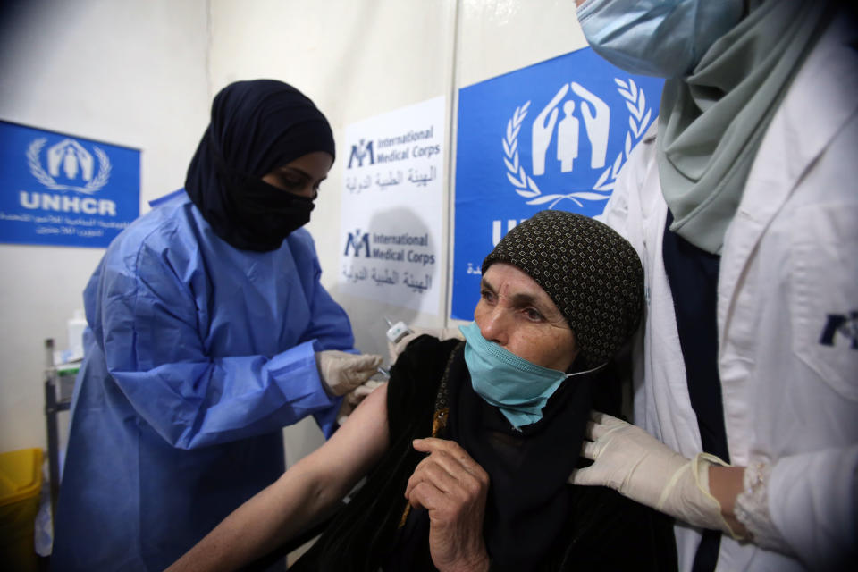 ZAATARI CAMP, JORDAN - FEBRUARY 16: Syrian refugees receive free Jordanian government COVID-19 vaccines with a UNHCR facilitating process at the first worldwide Covid-19 vaccination centre in a refugees camp on February 16, 2021 in Mafraq, Jordan. Zaatari, which was created in 2012 as Syrians fled their country's civil war, is the largest such camp for Syrian refugees. Life continues normally in the camp that hosts 78,000 Syrians with a total to-date 35 active corona cases and a total of 2000 cases. 250 random and selective PCR tests continue to be taken on a daily basis in the camp that marked 6 deaths of elderly people as all strict measures taken in the country are executed as well in the camp. (Photo by Jordan Pix/ Getty Images)