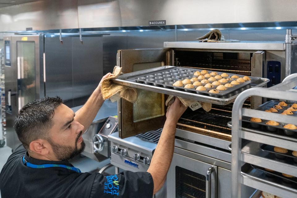 Chef Nick Guevara takes muffins out of the oven at The Lord's Place new 25,000-square-foot client service center at Fortin Family Campus celebrated with a ribbon cutting on October 19, 2023 in West Palm Beach, Florida. The center opened and began serving clients in early June.