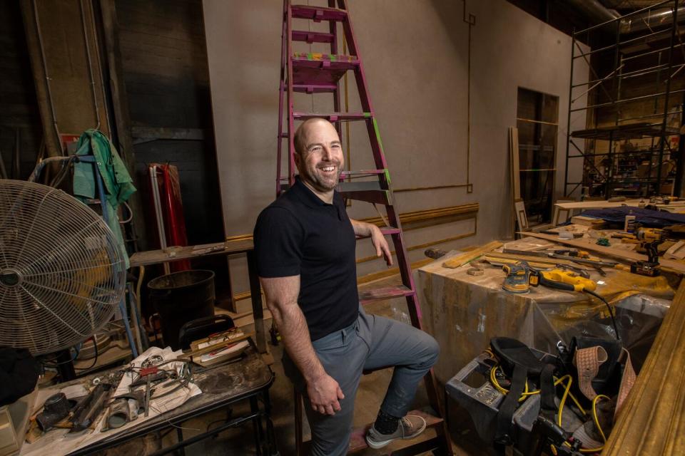 Danny Feldman stands in front of a ladder backstage at the Pasadena Playhouse.