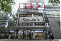 Flags fly on the front of Sotheby's auction house, in New York, Monday, June 17, 2019. BidFair USA is taking auction house Sotheby's private in a deal valued at $3.7 billion. (AP Photo/Richard Drew)