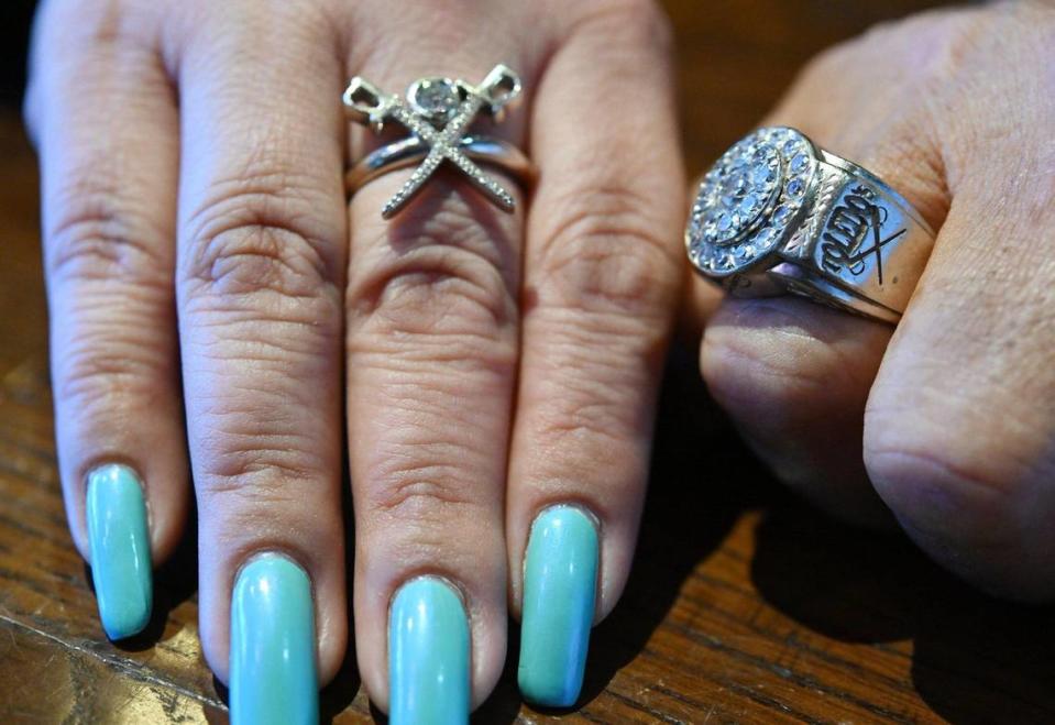 Carmen Toledo, left and her father Sam Toledo wear custom rings displaying the crossed swords of the restaurant’s logo and the family and restaurant’s name.