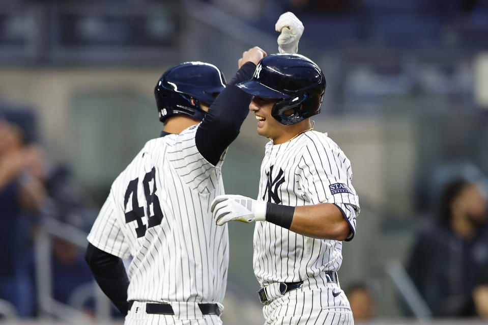 New York Yankees's Anthony Volpe, right, celebrates with Anthony Rizzo, left, after hitting a home run against the Miami Marlins during the fourth inning of a baseball game, Monday, April 8, 2024, in New York. (AP Photo/Noah K. Murray)