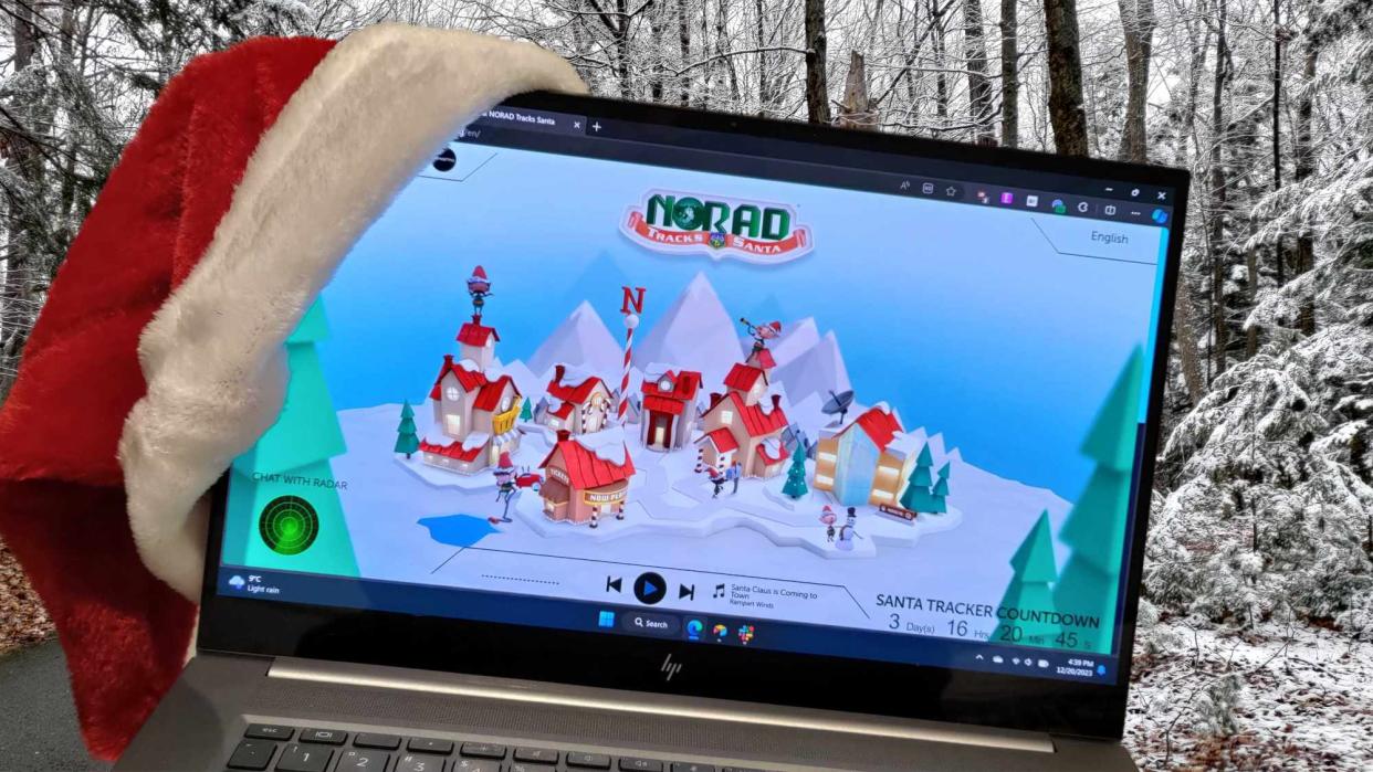  HP laptop wearing a Santa hat set on a snowscape. 