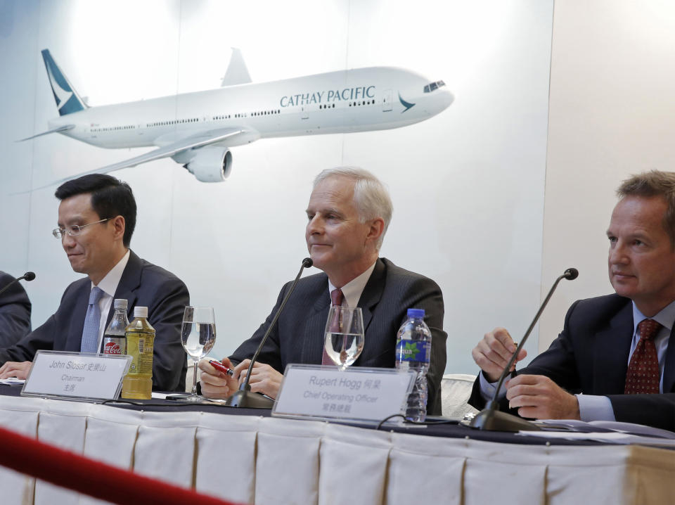 FILE - In this March 15, 2017, file photo, from right, Cathay Pacific Chief Operating Officer Rupert Hogg, Chairman John Slosar and Chief Executive Ivan Chu attend a news conference as they announce the company result in Hong Kong. Hogg resigned Friday, Aug. 16, 2019, following pressure by Beijing on the Hong Kong carrier over participation by some of its employees in anti-government protests. (AP Photo/Kin Cheung, File)