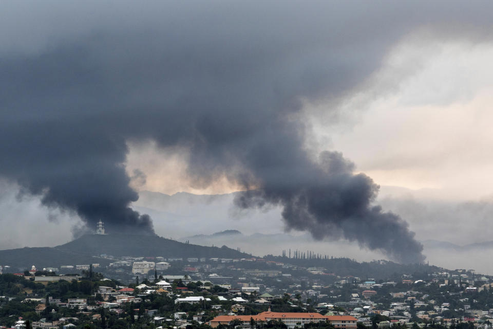 FILE - Smoke rises during protests in Noumea, New Caledonia, on May 15, 2024. Global nickel prices have soared since deadly violence erupted in the French Pacific territory of New Caledonia. (AP Photo/Nicolas Job, File)