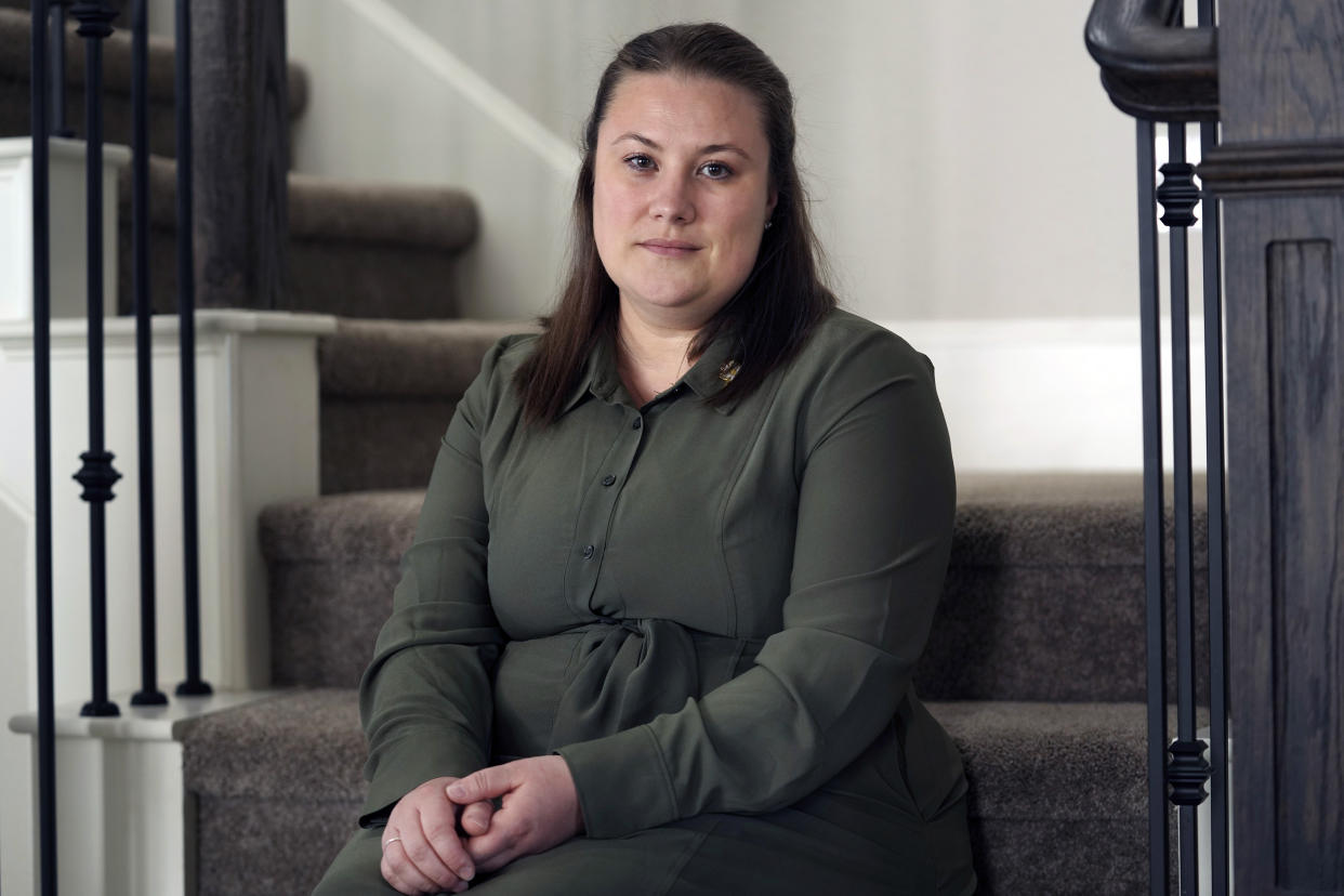 Jessica Bernardo, who has joined the Texas abortion lawsuit, sits on the stairs at her home.