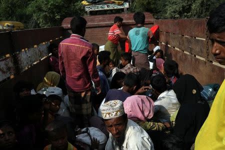 Newly arrived Rohingya refugees sit on a truck to take them to get registered after crossing the Bangladesh-Myanmar border at a relief centre in the Teknaf area, Bangladesh, November 23, 2017. REUTERS/Susana Vera