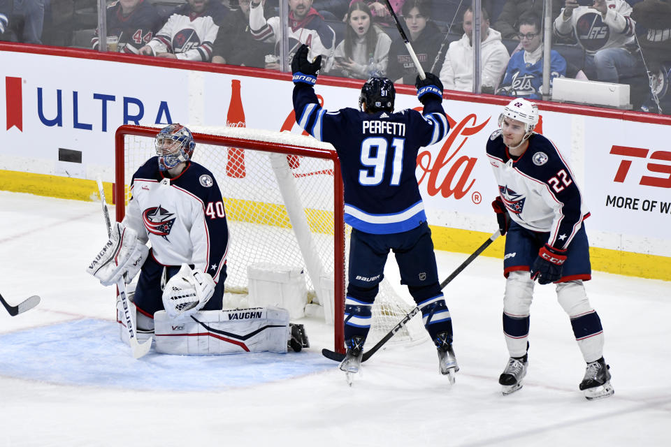 Winnipeg Jets' Cole Perfetti (91) celebrates his goal begtween Columbus Blue Jackets' goaltender Daniil Tarasov (40) and Jake Bean (22) during the second period of an NHL hockey game Tuesday, Jan. 9, 2024, in Winnipeg, Manitoba. (Fred Greenslade/The Canadian Press via AP)