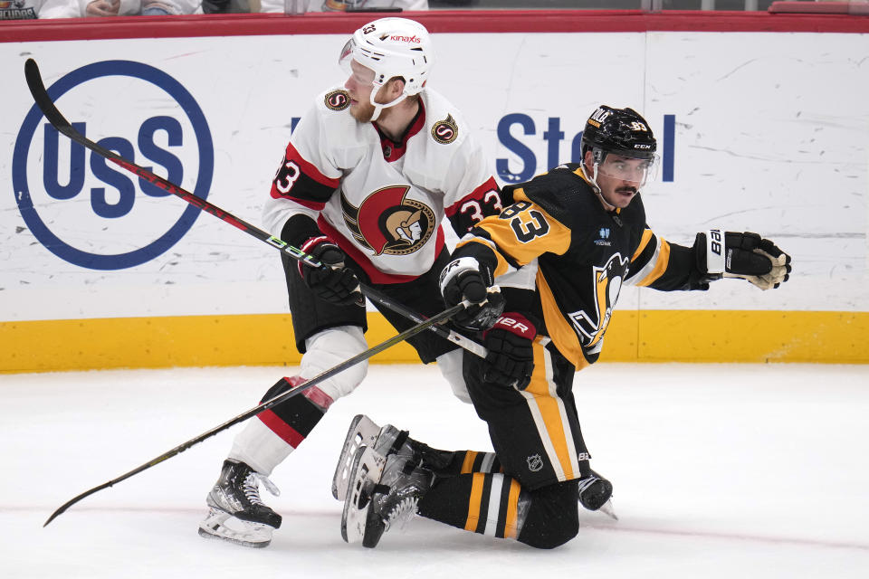 Pittsburgh Penguins' Matt Nieto (83) collides with Ottawa Senators' Nikolas Matinpalo during the third period of an NHL hockey game in Pittsburgh, Saturday, Oct. 28, 2023. (AP Photo/Gene J. Puskar)