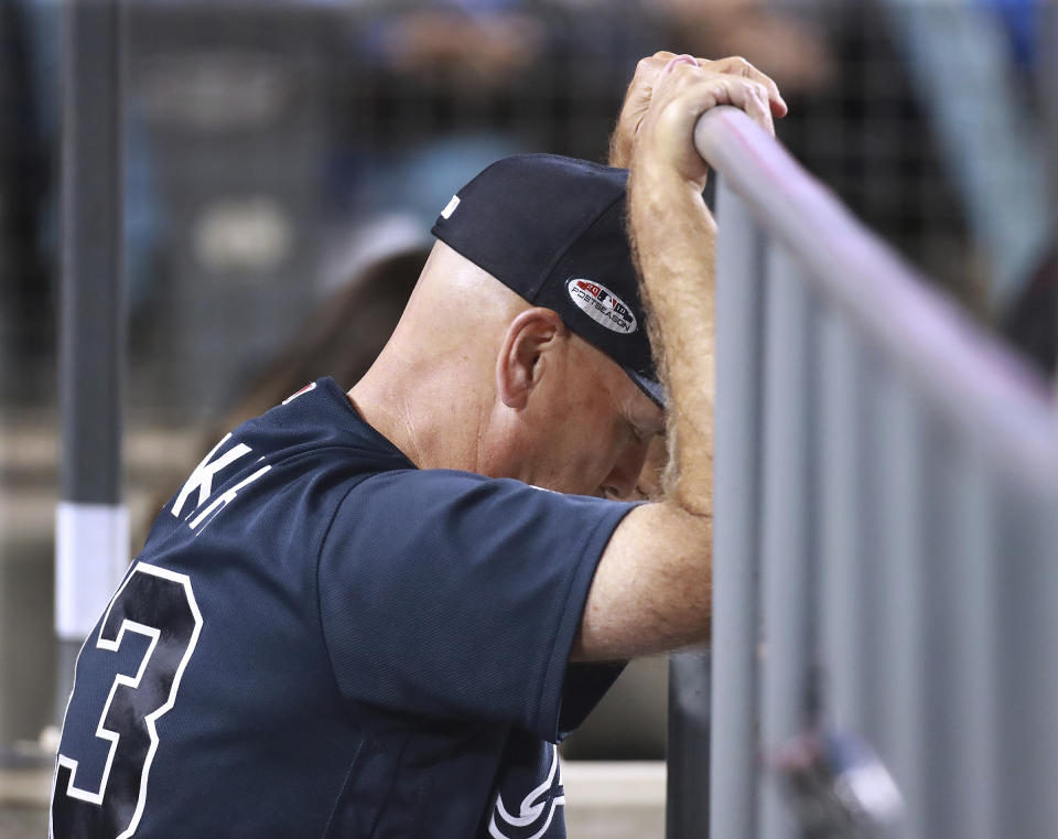 Atlanta Braves manager Brian Snitker pauses while watching from the dugout during the team's 6-0 loss to the Los Angeles Dodgers in Game 1 of a baseball National League Division Series, Thursday, Oct. 4, 2018, in Los Angeles. (Curtis Compton/Atlanta Journal Constitution via AP)