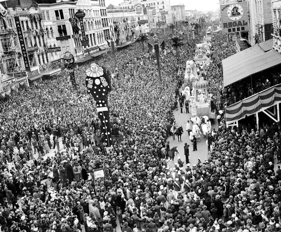 Mardi Gras revelers gather at Canal Street as Rex, King of Carnival, makes his way aboard his float through the crowd Feb. 26, 1941, in New Orleans La. An estimate of half a million people lined the streets for the festivities. (AP Photo,file)