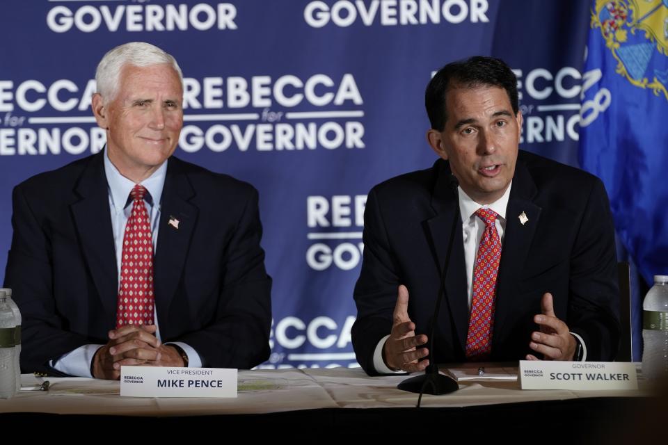 Former Vice President Mike Pence and former Wisconsin Gov. Scott Walker participate in a round table discussion Wednesday, Aug. 3, 2022, in Pewaukee, Wis. (AP Photo/Morry Gash)