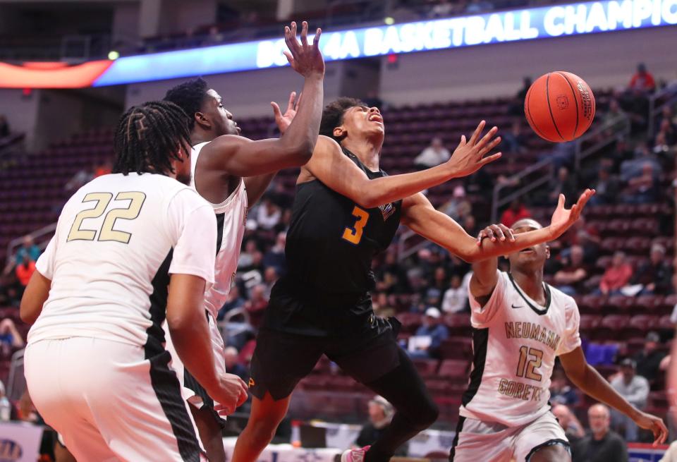 Lincoln Park's Brandin Cummings (3) gets fouled by Neumann-Goretti's Amir Williams (12) while going for a layup during the second half of the PIAA 4A Championship game Thursday night at the Giant Center in Hershey, PA.