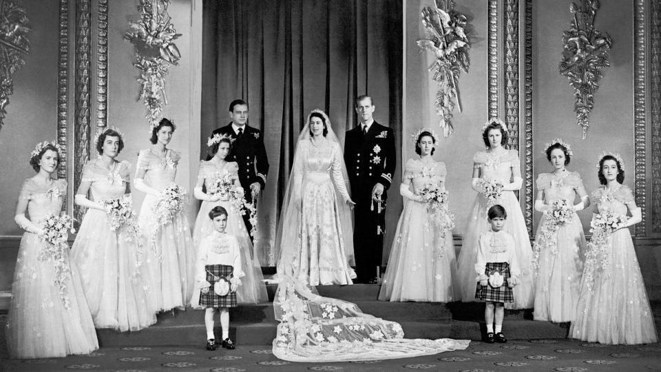 Princess Elizabeth and the Duke of Edinburgh with their eight bridesmaids in the Throne Room at Buckingham Palace.