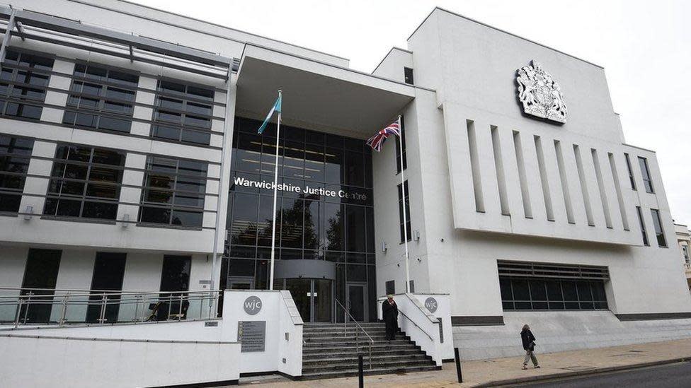 The exterior of Warwick Crown Court. Modern building in white render with large dark windows