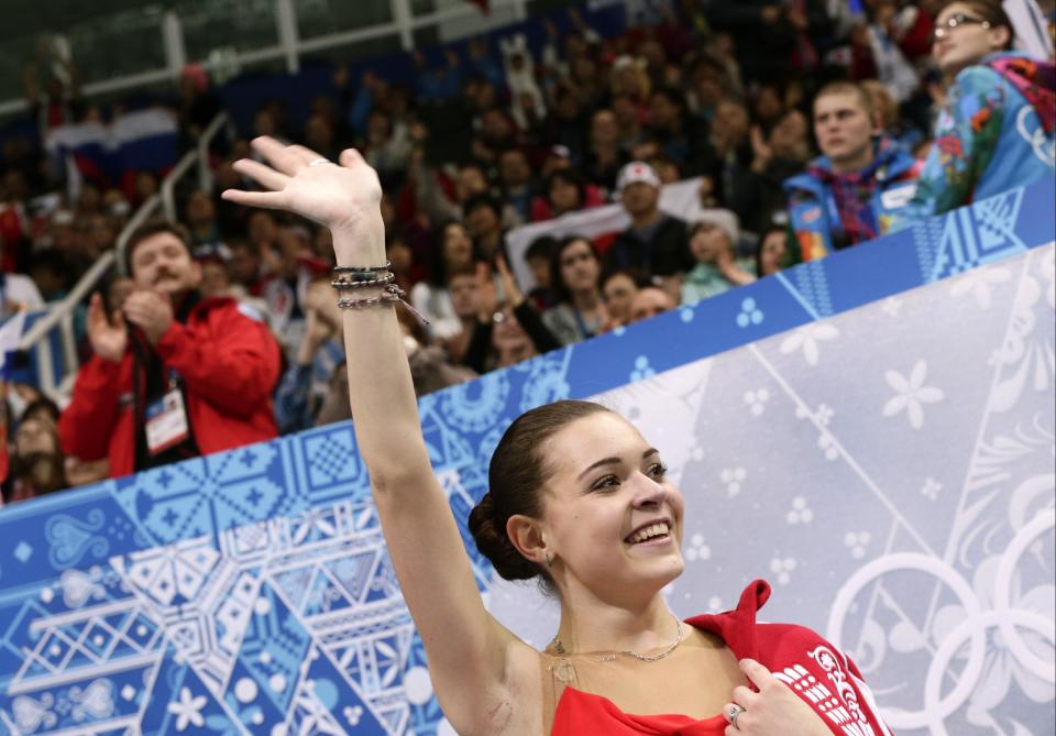 Adelina Sotnikova of Russia waves to spectators as she waits in the results area after completing her routine in the women's short program figure skating competition at the Iceberg Skating Palace during the 2014 Winter Olympics, Wednesday, Feb. 19, 2014, in Sochi, Russia. (AP Photo/Bernat Armangue)