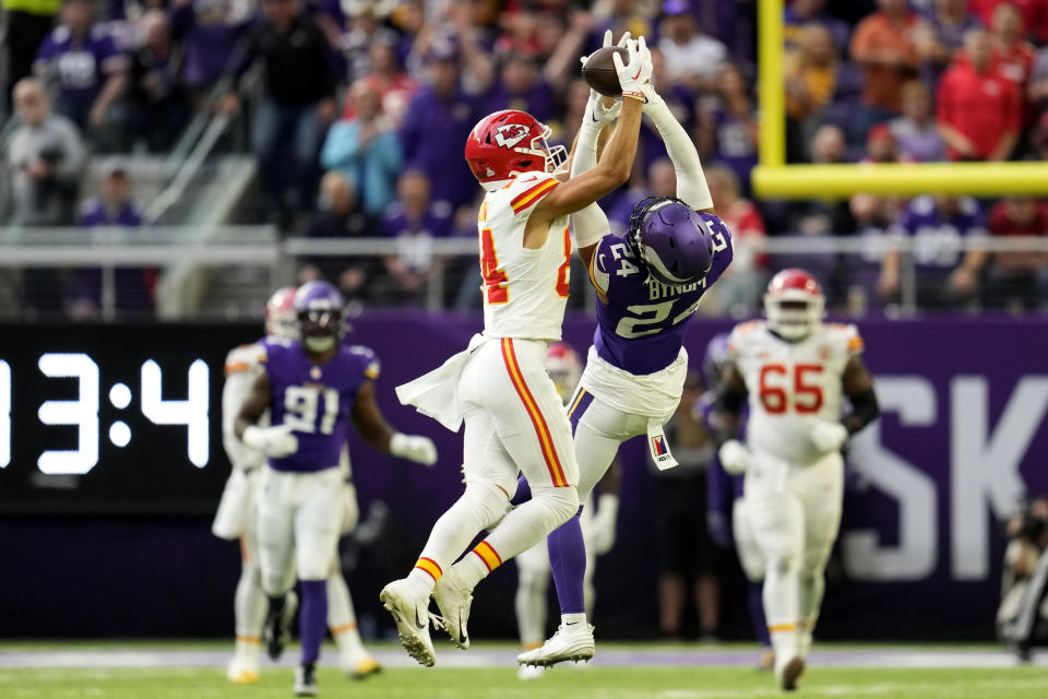 Kansas City Chiefs wide receiver Justin Watson (84) catches a pass over Minnesota Vikings safety Camryn Bynum (24) during the second half of an NFL football game, Sunday, Oct. 8, 2023, in Minneapolis. (AP Photo/Abbie Parr)