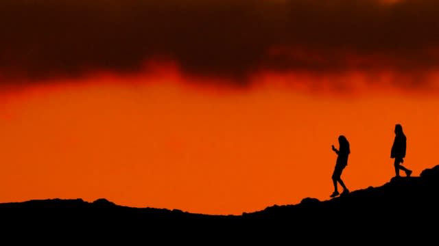 People hike at dusk near Phoenix, Arizona