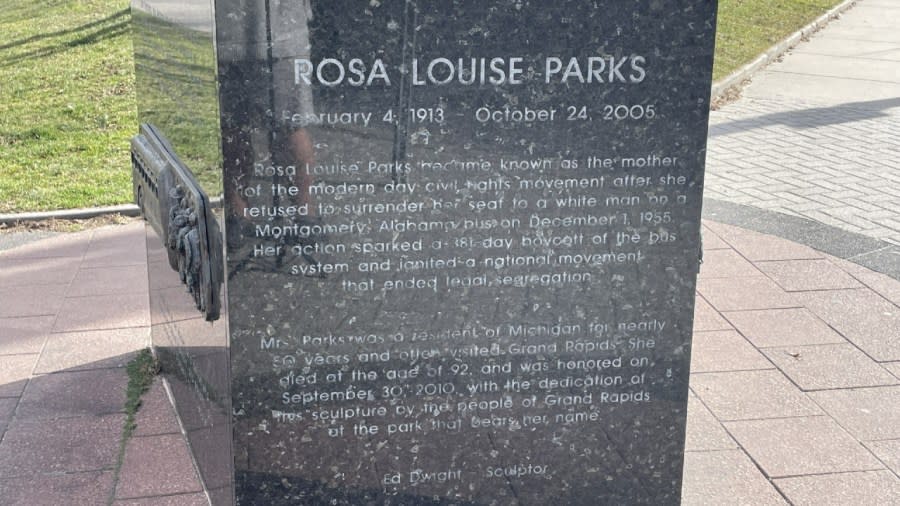 The base of the statue reads: "Rosa Louise Parks became known as the mother of the modern day civil rights movement after she refused to surrender her seat to a white man on a Montgomery, Alabama bus on Dec. 1, 1955. Her action sparked a 381-day boycott of the bus system and ignited a national movement that ended in legal segregation. Mrs. Parks was a resident of Michigan for nearly 50 years and often visited Grand Rapids. She died at the age of 92 and was honored on Sept. 30, 2010, with the dedication of this sculpture by the people of Grand Rapids at the park that bears her name.