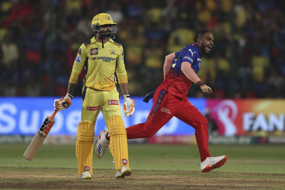 Royal Challengers Bengaluru's Yash Dayal , right, celebrates after winning the Indian Premier League cricket against Chennai Super Kings in Bengaluru, India, Sunday, May 19 , 2024. (AP Photo/Kashif Masood)