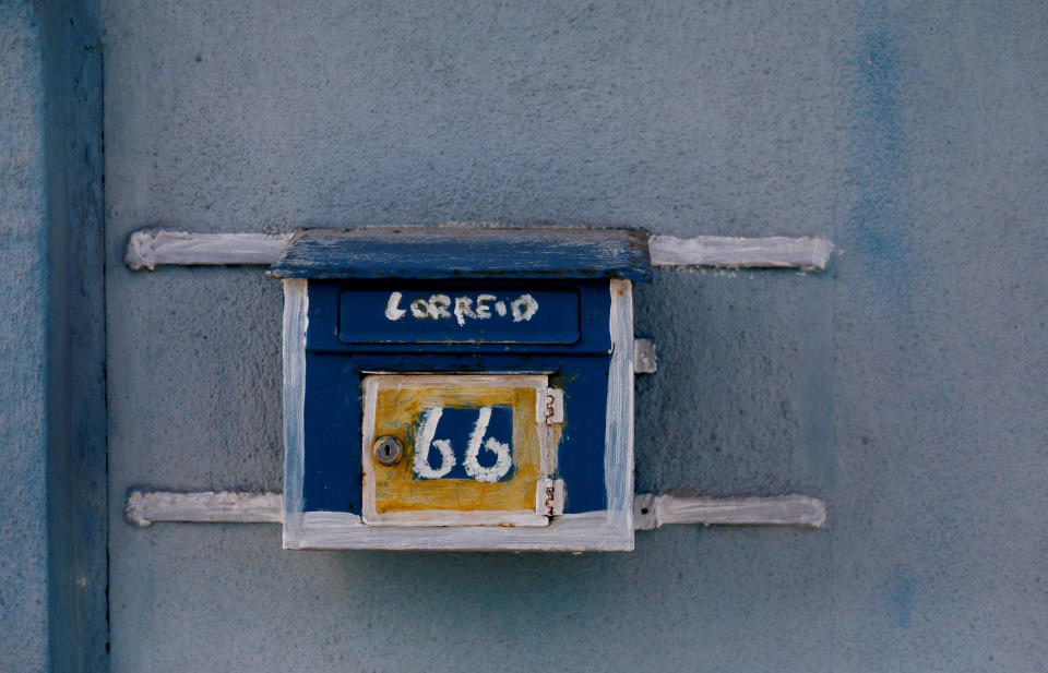 A postbox hangs on a street in Cova da Moura 
