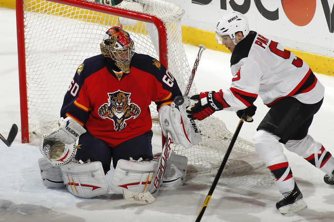  Goaltender Jose Theodore #60 Of The Florida Panthers Defends The Net As Zach Parise #9 Of The New Jersey Devils Hits Getty Images