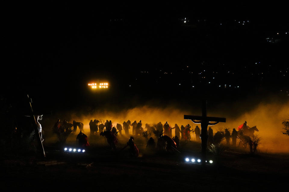 Faithful take part in a Way of the Cross reenactment, as part of Holy Week celebrations, in Colina, Chile, Friday, March 29, 2024. Holy Week commemorates the last week of Jesus' earthly life which culminates with his crucifixion on Good Friday and his resurrection on Easter Sunday. (AP Photo/Esteban Felix)