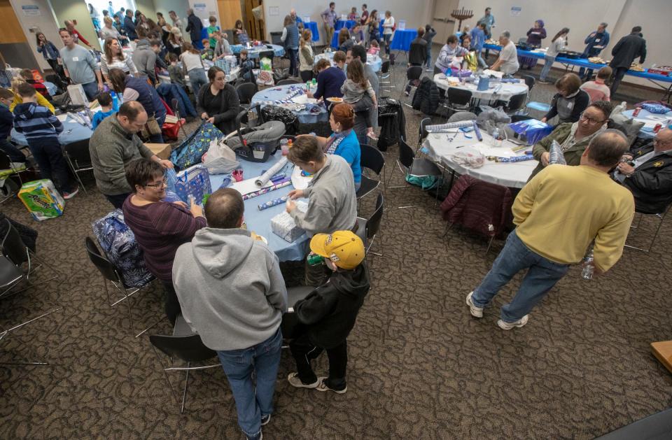 Packed tables for a gift wrapping event at the Jewish Community Center on Sunday, Dec. 8, 2019.