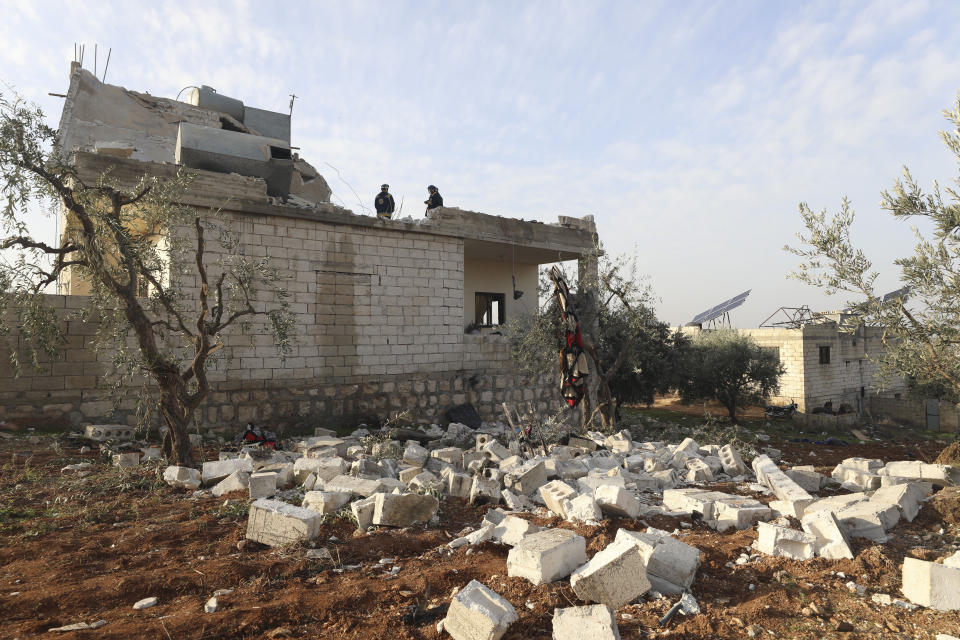 People check a destroyed house after an operation by the U.S. military in the Syrian village of Atmeh, in Idlib province, Syria, Thursday, Feb. 3, 2022. U.S. special forces carried out what the Pentagon said was a successful, large-scale counterterrorism raid in northwestern Syria early Thursday. Local residents and activists said civilians were also among the dead. (AP Photo/Ghaith Alsayed)