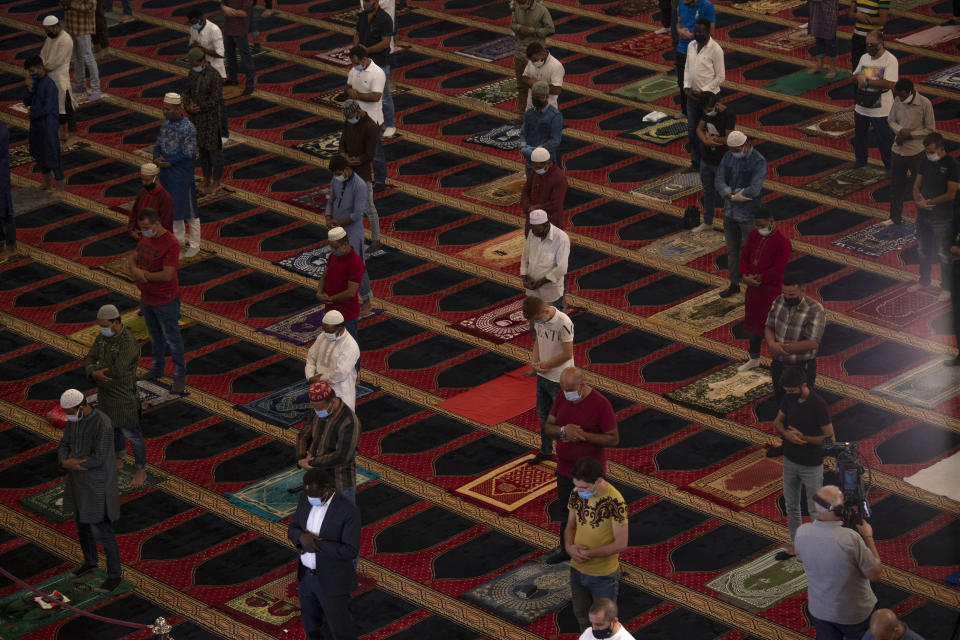 Muslim worshippers wearing masks to help stop the spread of the coronavirus, offer Eid al-Adha prayer while maintaining a social distance at the Mohammad al-Amin Mosque in Beirut, Lebanon, Friday, July 31, 2020. Eid al-Adha, or Feast of Sacrifice, Islam's most important holiday marks the willingness of the Prophet Ibrahim to sacrifice his son. (AP Photo/Hassan Ammar)