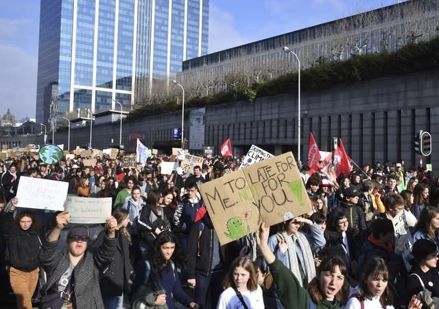 Demonstrators hold placards during a march for the climate in Brussels