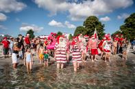 <p>Actors dressed as Santa Claus take a refreshing bath at Bellevue Beach in Klampenborg north of Copenhagen, Denmark, on July 24, 2018, as they take part in the World Santa Congress, an annual two-day event held every summer in Copenhagen. (Photo: Mads Claus Rasmussen/Ritzau Scanpix/AFP/Getty Images) </p>