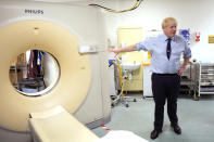 British Prime Minister Boris Johnson meets staff and sees an MRI CT Scanner during a visit to The Princess Alexandra hospital in Harlow, England, Friday, Sept. 27, 2019. Dominic Cummings, senior adviser to British Prime Minister Boris Johnson, has dismissed concerns that politicians' heated rhetoric over Brexit is polarizing society, telling supporters that it isn't surprising that people are upset about the country's failure to leave the European Union. (Stefan Rousseau/Pool Photo via AP)