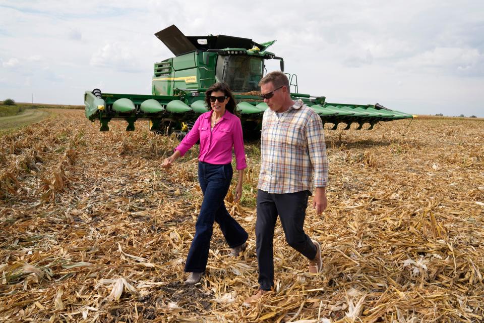 Republican presidential candidate former U.N. Ambassador Nikki Haley talks with farmer Dennis Campbell, right, during a tour of the Crystal Creek Enterprises farm, Friday, Sept. 15, 2023, in Grand Mound, Iowa. (AP Photo/Charlie Neibergall)