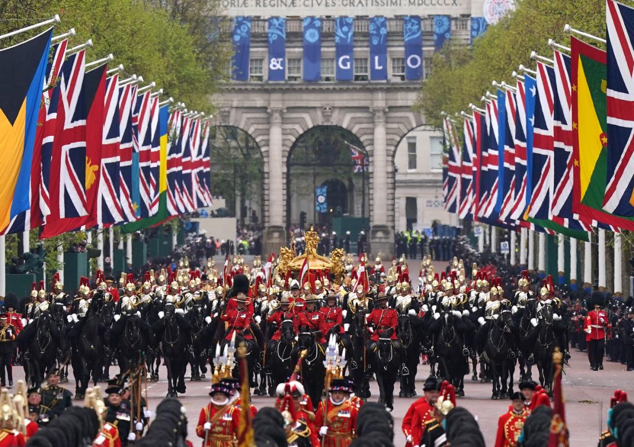 king charles iii and queen camilla are carried in the gold state coach, pulled by eight windsor greys, in the coronation procession as they return along the mall to buckingham palace, london, following their coronation ceremony thousands of members of the armed forces from across the commonwealth and british overseas territories, members of the uk armed forces and the sovereigns bodyguard and royal watermen, are taking part in the celebrations through central london in the largest military operation in 70 years picture date saturday may 6, 2023 photo by niall carsonpa images via getty images