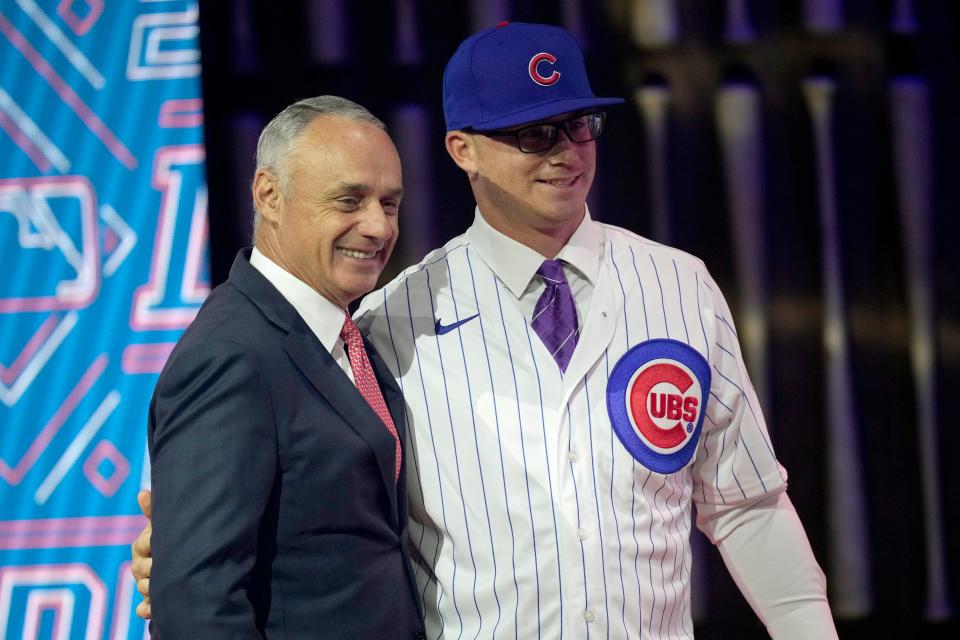 Kansas State's Jordan Wicks stands with MLB Commissioner Rob Manfred after being selected by Chicago Cubs as the 21st pick in the first round of the 2021 MLB baseball draft on Sunday, July 11, 2021, in Denver.