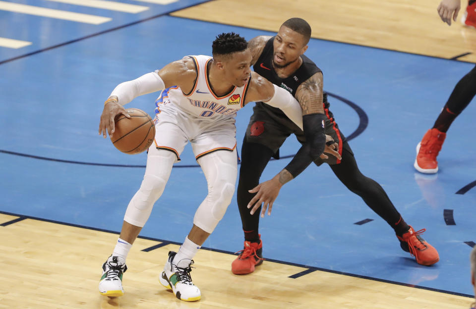 Oklahoma City Thunder guard Russell Westbrook (0) drives to the basket as Portland Trail Blazers guard Damian Lillard (0) defends in the first half of Game 4 of an NBA basketball first-round playoff series Sunday, April 21, 2019, in Oklahoma City. (AP Photo/Alonzo Adams)