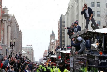 Feb 4, 2015; Boston, MA, USA; New England Patriots wide receiver Julian Edelman (top right) gestures to the fans during the Super Bowl XLIX victory parade. Stew Milne-USA TODAY Sports