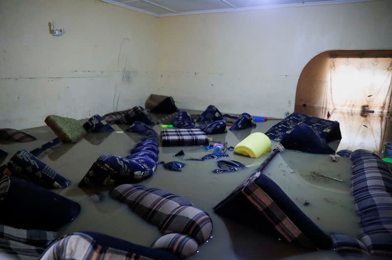 House furniture is marooned in flood water after a seasonal river burst its banks following heavy rainfall in Kitengela municipality of Kajiado County