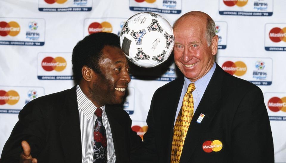 Pele and Bobby Charlton pose with a match ball for a picture during Euro ‘96. (Getty Images)