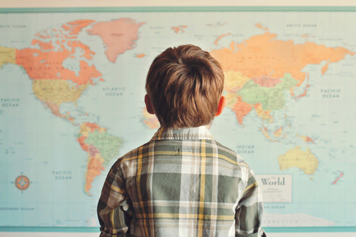 Little boy looking at world map