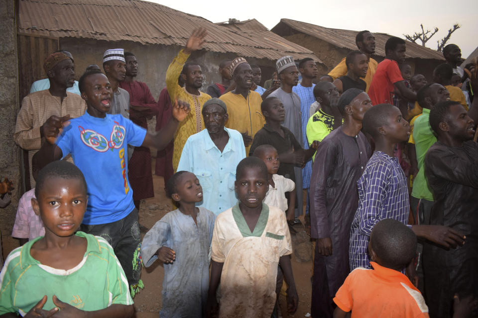 People gather around an area were gunmen kidnapped school children in Chikun, Nigeria, Thursday, March 7, 2024. Gunmen attacked a school in Nigeria's northwest region Thursday morning and abducted at least 287 students, the headteacher told authorities, marking the second mass abduction in the West African nation in less than a week. (AP Photo)