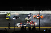DAYTONA BEACH, FL - FEBRUARY 18: Matt Kenseth, driver of the #17 Best Buy Ford, Dale Earnhardt Jr., driver of the #88 Diet Mountain Dew/National Guard Chevrolet, Martin Truex Jr., driver of the #56 NAPA Auto Parts Toyota, Joey Logano, driver of the #20 The Home Depot Toyota, and Kevin Harvick, driver of the #29 Budweiser Chevrolet, crash during the NASCAR Budweiser Shootout at Daytona International Speedway on February 18, 2012 in Daytona Beach, Florida. (Photo by Jamie Squire/Getty Images)