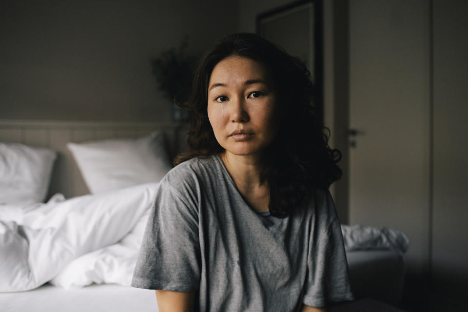 woman sitting at the edge of the bed